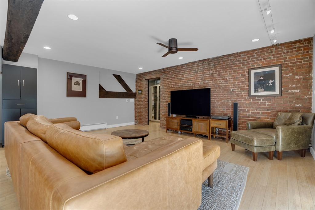 9 Appleton Street, Unit M1 Boston, MA 02116 - Photo 4 of 24 a living room with furniture flat screen tv and a fireplace