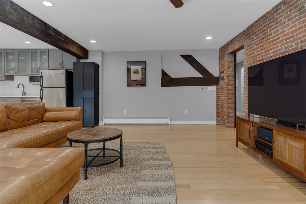 9 Appleton Street, Unit M1 Boston, MA 02116 - Photo 5 of 24 a living room with furniture and a flat screen tv