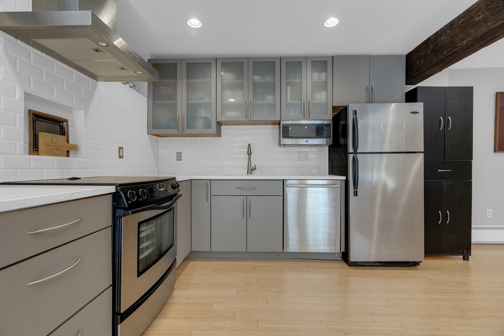 9 Appleton Street, Unit M1 Boston, MA 02116 - Photo 10 of 24 a kitchen with stainless steel appliances granite countertop a refrigerator a sink and a stove