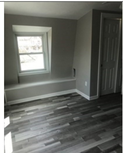 847 Washington Street, Unit 2FRONT Canton, MA 02021 - Photo 13 of 14 a room with a window and a wooden floor