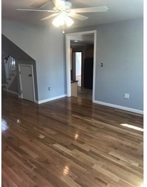 847 Washington Street, Unit 2FRONT Canton, MA 02021 - Photo 5 of 14 a view of a room with wooden floor and fan