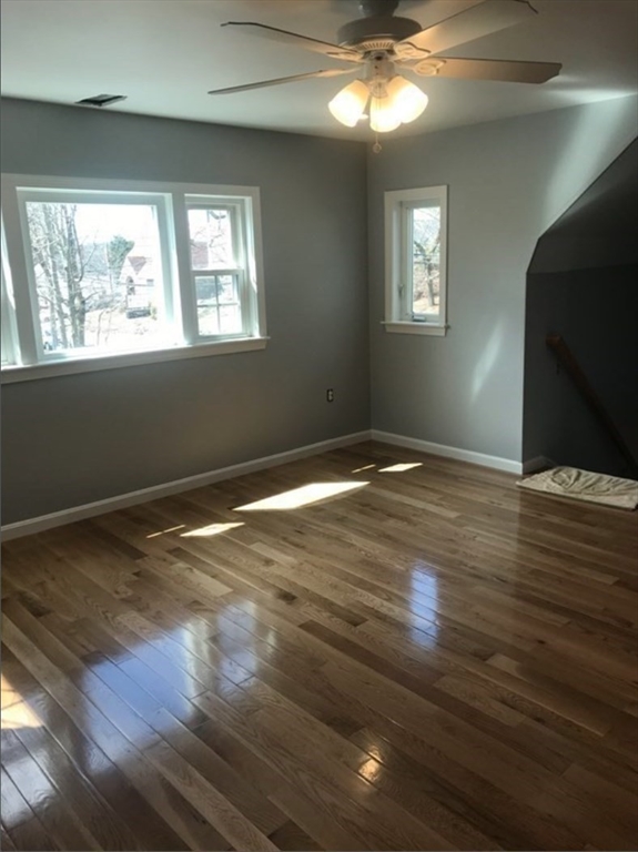 847 Washington Street, Unit 2FRONT Canton, MA 02021 - Photo 6 of 14 a view of an empty room with wooden floor and a window