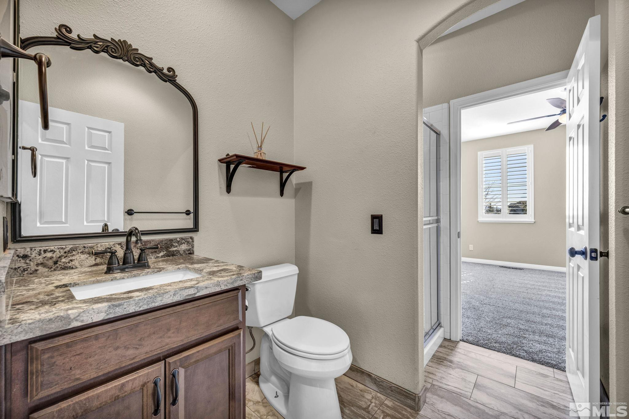 3471 Forest View Court Reno, NV 89511 - Photo 20 of 38 a bathroom with a granite countertop toilet sink and shower