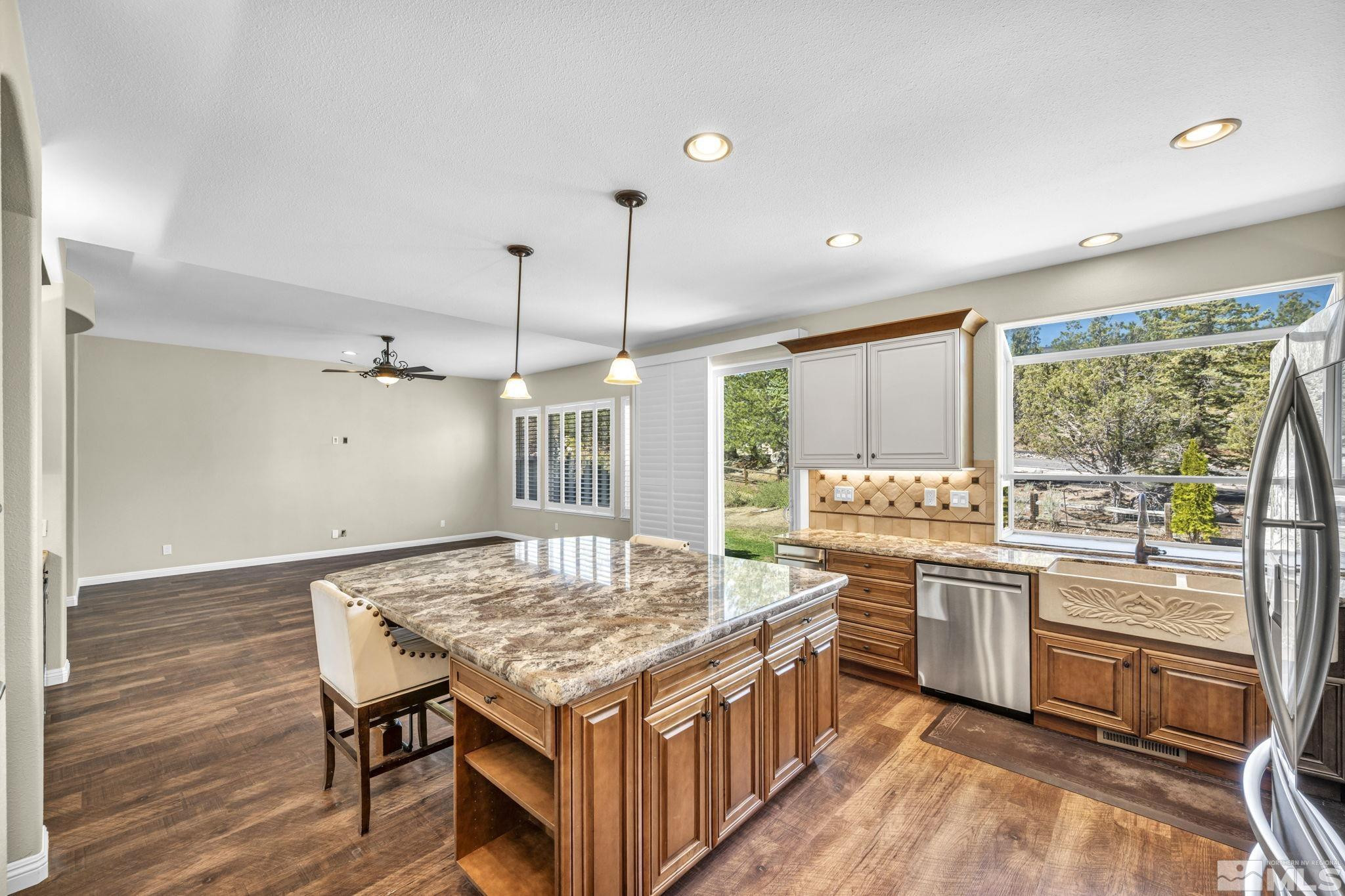 3471 Forest View Court Reno, NV 89511 - Photo 35 of 38 a kitchen with a stove a refrigerator a sink dishwasher with a dining table and chairs
