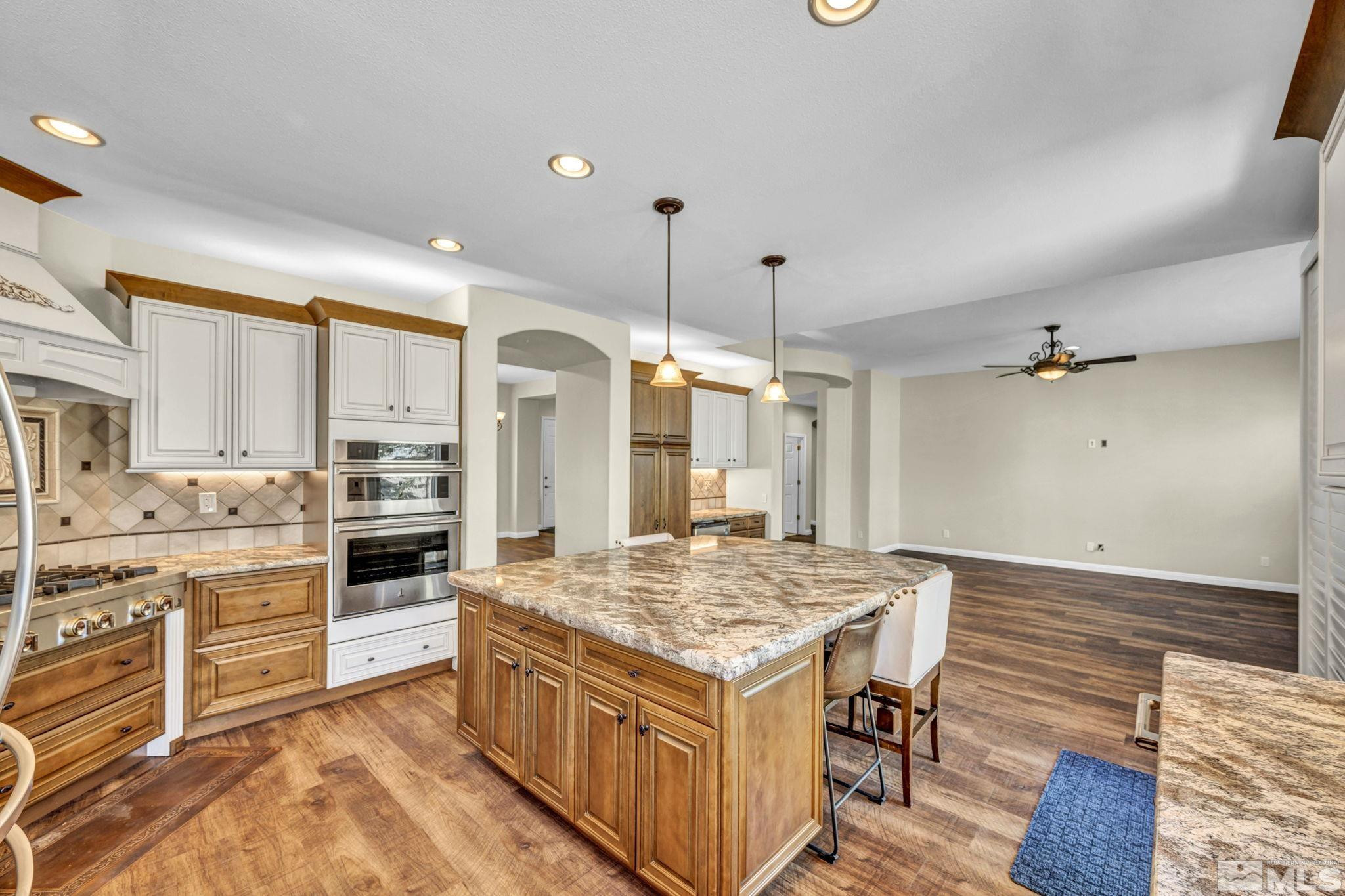 3471 Forest View Court Reno, NV 89511 - Photo 6 of 38 a kitchen with a stove a sink and a refrigerator