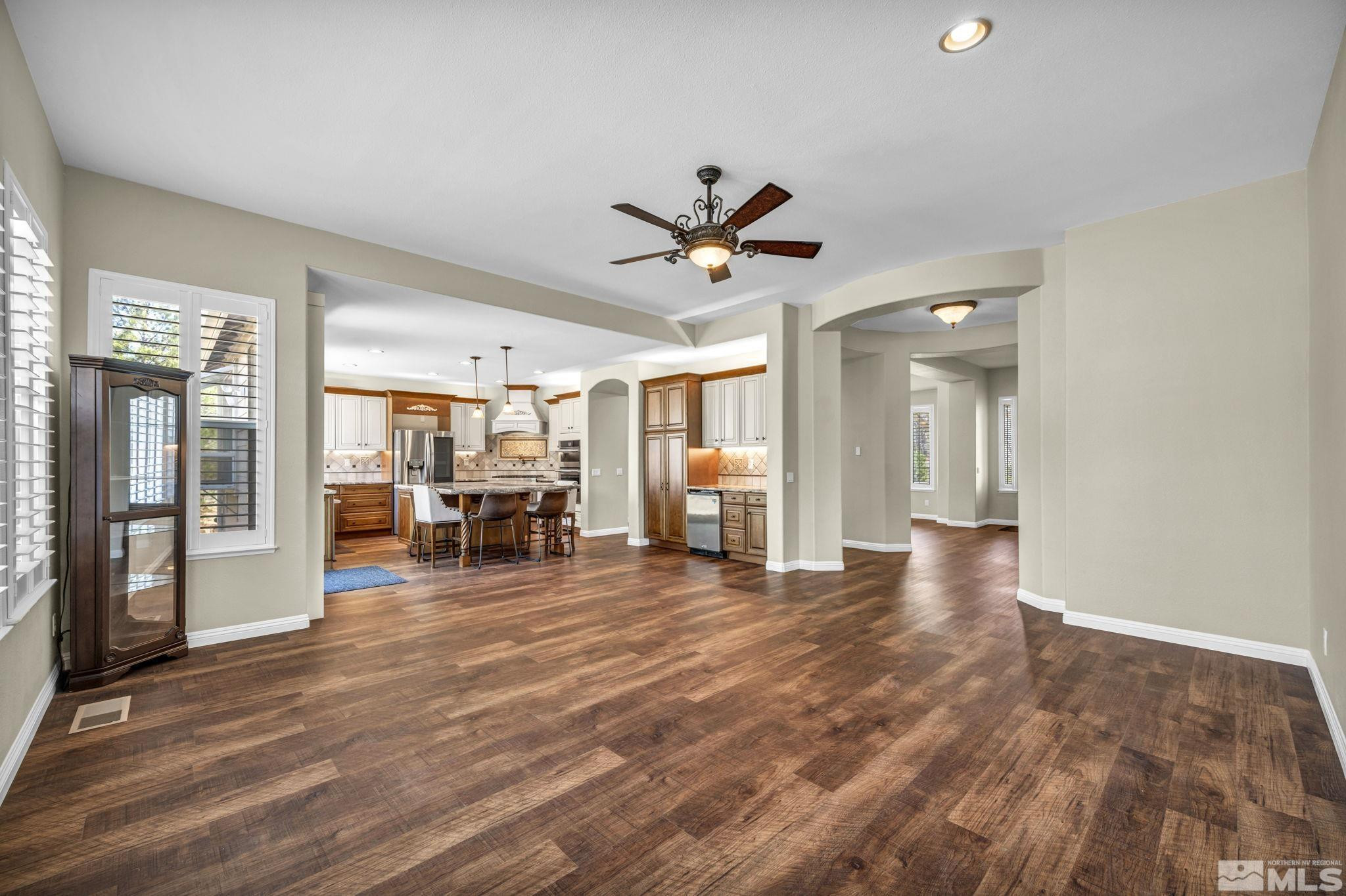 3471 Forest View Court Reno, NV 89511 - Photo 7 of 38 a view of a livingroom with a flat screen tv and couches with wooden floor