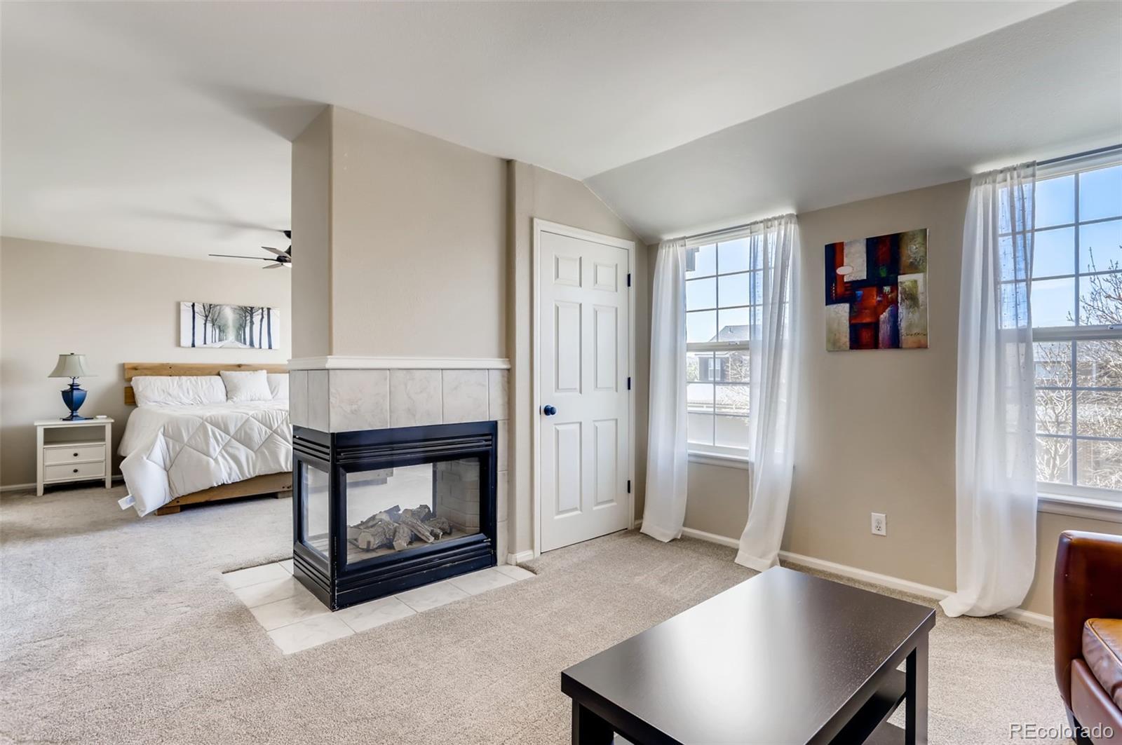 1091 Riddlewood Road Highlands Ranch, CO 80129 - Photo 11 of 26 a living room with furniture and a fireplace
