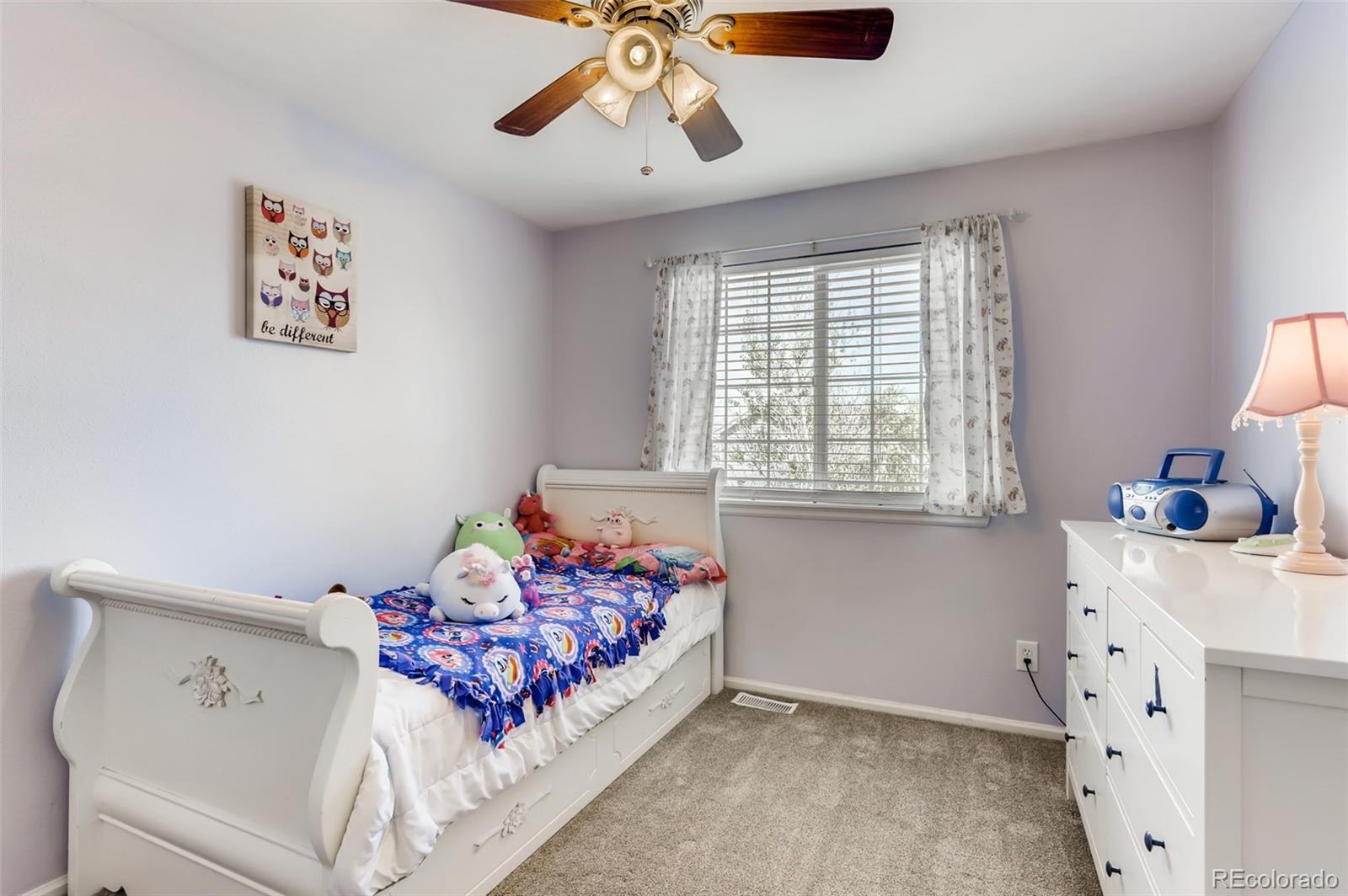 1091 Riddlewood Road Highlands Ranch, CO 80129 - Photo 17 of 26 a bedroom with a bed and window
