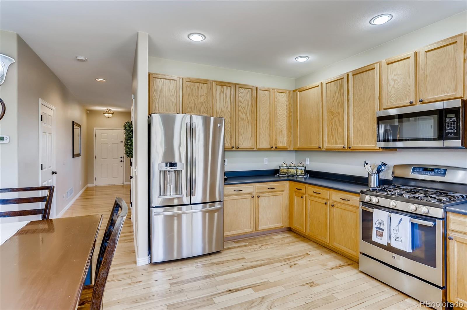 1091 Riddlewood Road Highlands Ranch, CO 80129 - Photo 8 of 26 a kitchen with stainless steel appliances granite countertop a refrigerator a stove top oven a sink and dishwasher