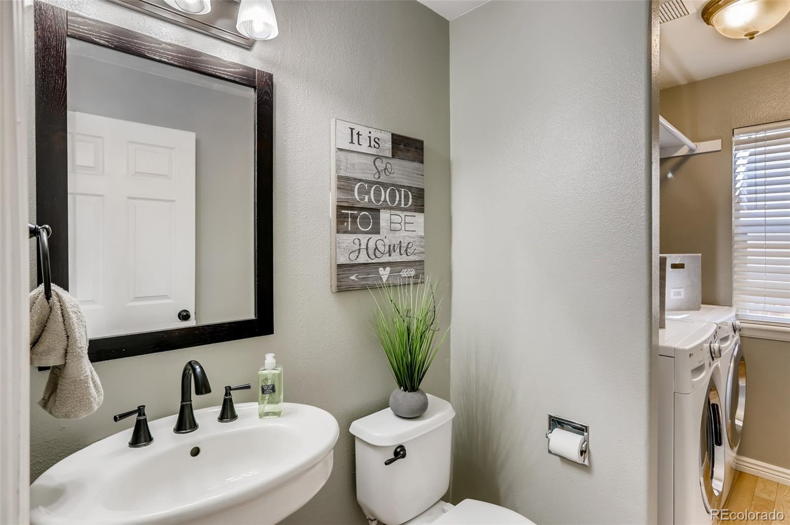 1091 Riddlewood Road Highlands Ranch, CO 80129 - Photo 9 of 26 a bathroom with a toilet sink and mirror