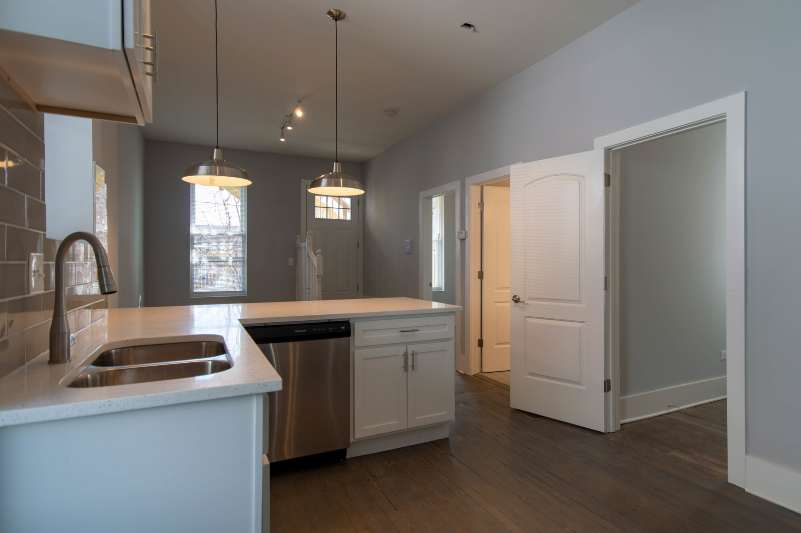 2117 West 18th Street, Unit 1R Chicago, IL 60608 - Photo 2 of 8 a kitchen with white cabinets and sink