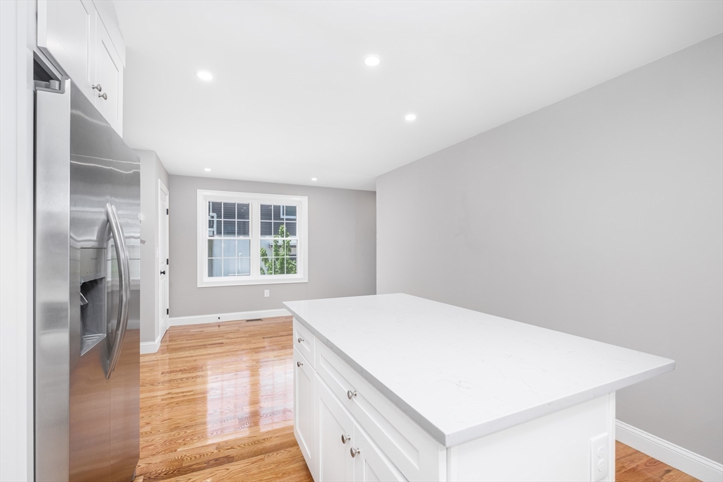 216 Vane Street, Unit 2 Revere, MA 02151 - Photo 2 of 22 a kitchen with a refrigerator and a sink