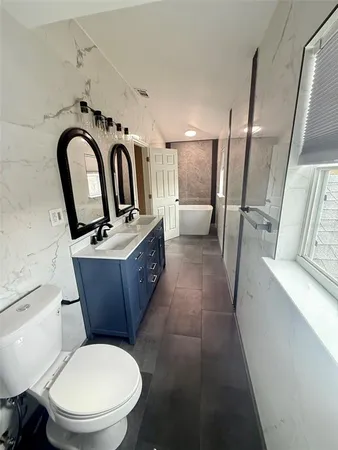 a bathroom with a toilet sink and mirror