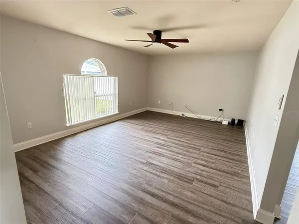 wooden floor in an empty room with a window