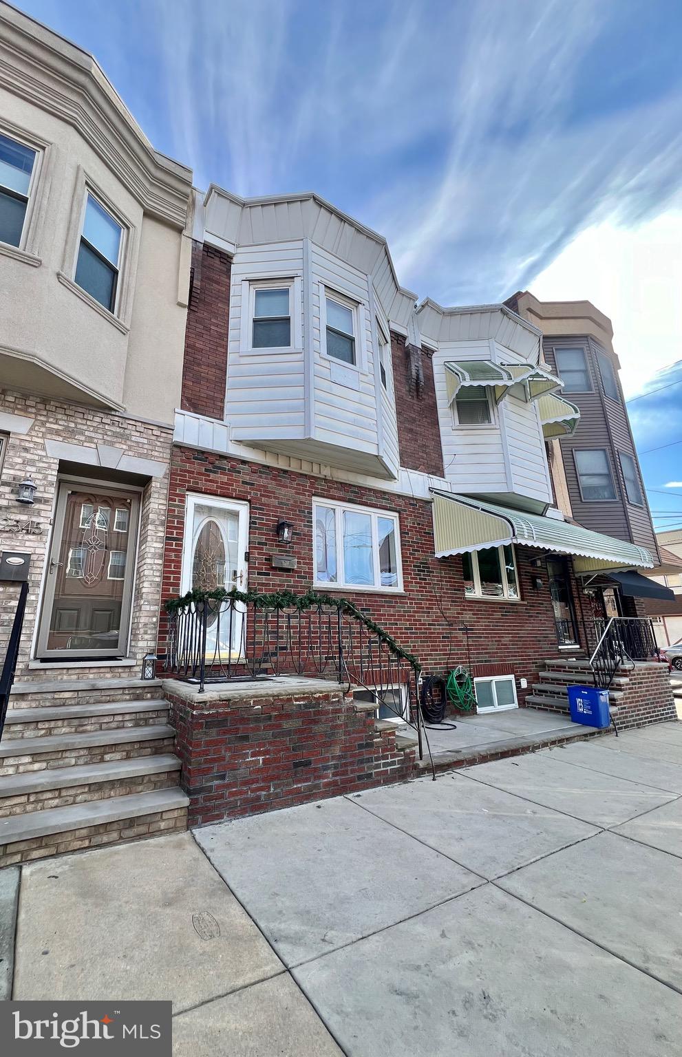 a front view of a building with sitting area
