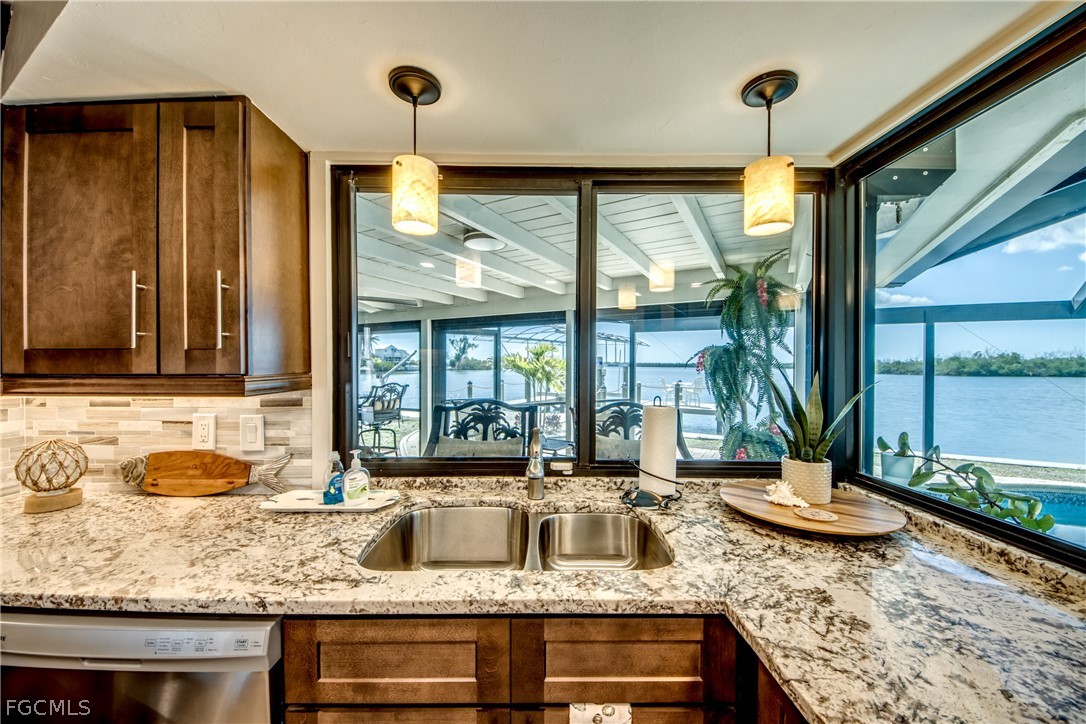 11599 Island Avenue Matlacha, FL 33993 - Photo 13 of 38 a kitchen with granite countertop a sink and a counter top space