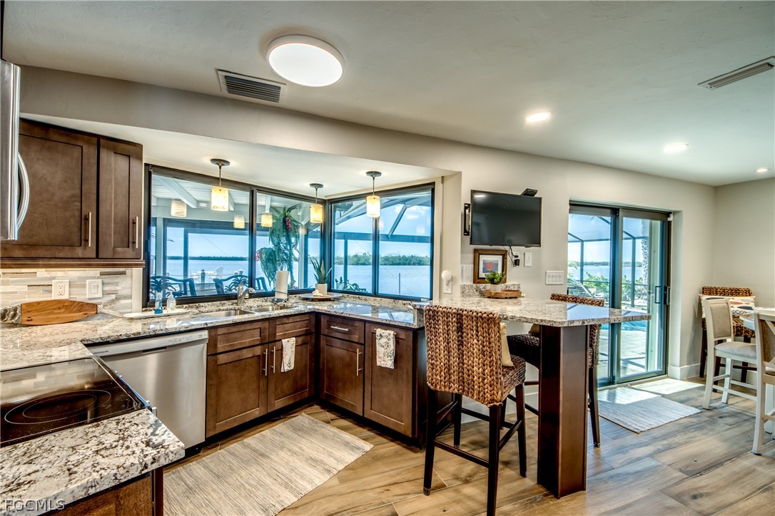 11599 Island Avenue Matlacha, FL 33993 - Photo 14 of 38 a kitchen with a sink a counter top space appliances and a window