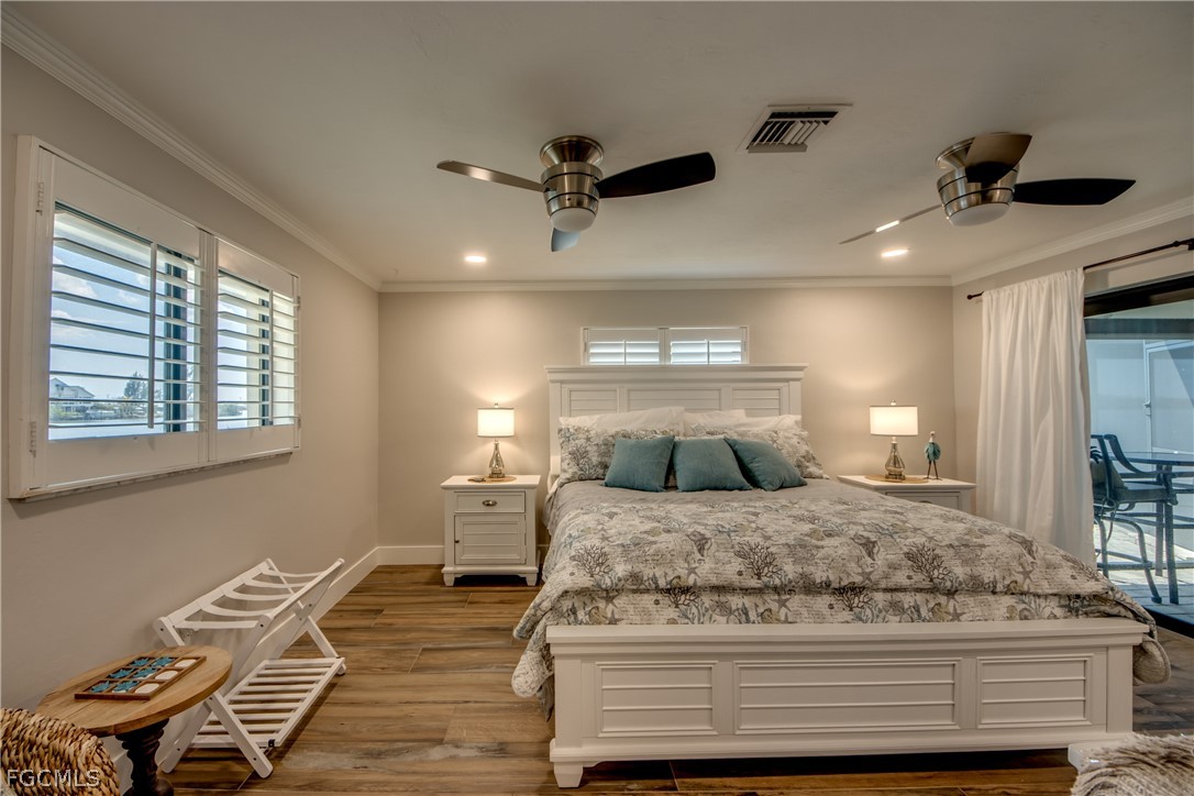 11599 Island Avenue Matlacha, FL 33993 - Photo 16 of 38 a bedroom with a bed and wooden floor