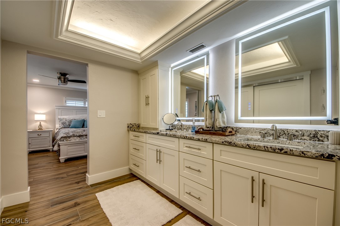 11599 Island Avenue Matlacha, FL 33993 - Photo 19 of 38 a en suite bathroom with double sink and a mirror