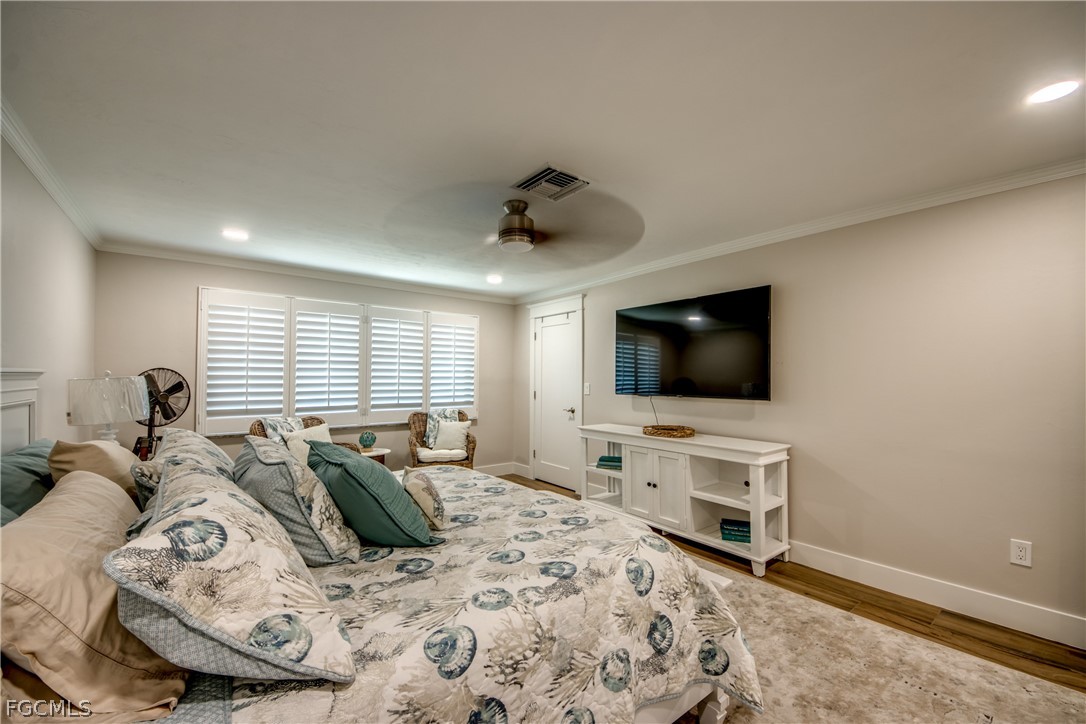 11599 Island Avenue Matlacha, FL 33993 - Photo 22 of 38 a bedroom with a bed and a flat screen tv