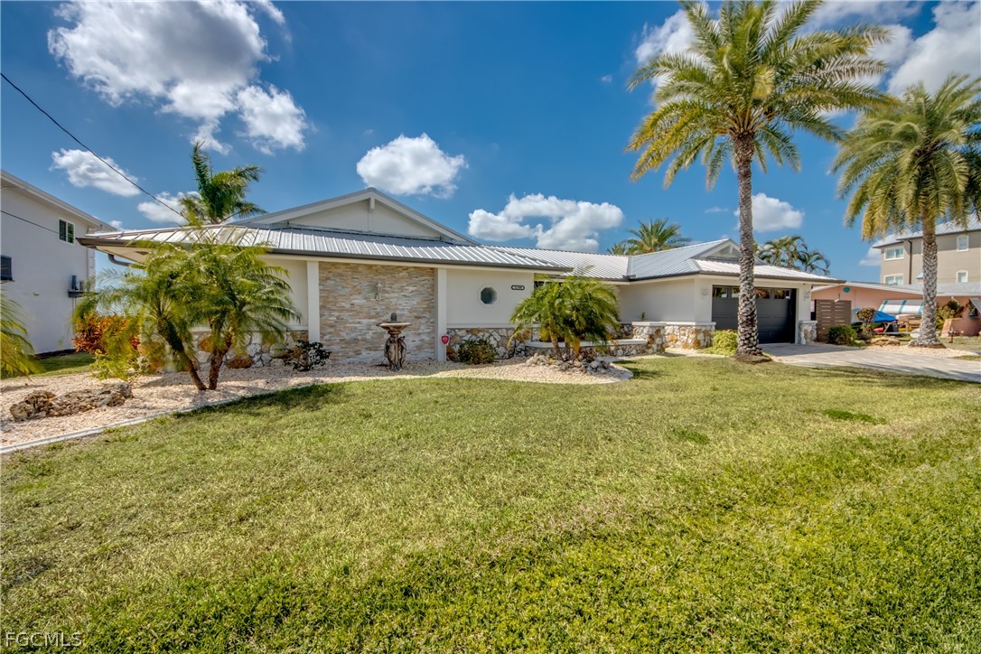 11599 Island Avenue Matlacha, FL 33993 - Photo 3 of 38 a front view of a house with garden