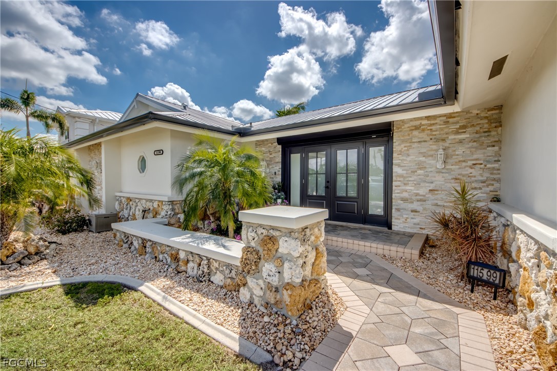 11599 Island Avenue Matlacha, FL 33993 - Photo 4 of 38 a front view of a house with garden