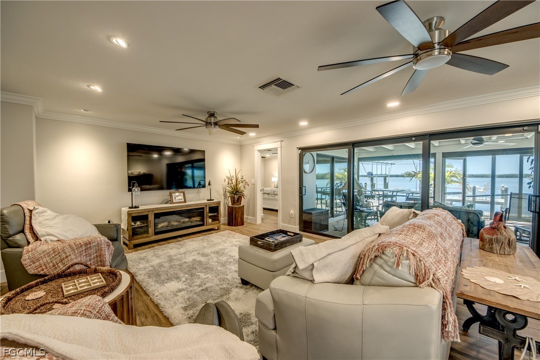 11599 Island Avenue Matlacha, FL 33993 - Photo 7 of 38 a living room with furniture and a flat screen tv