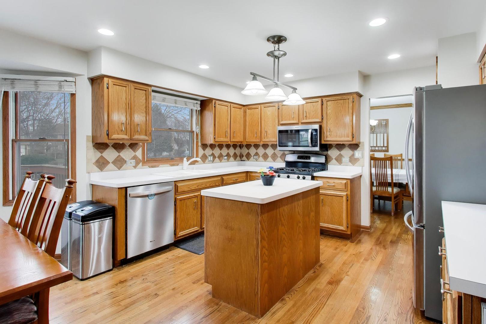 873 Hampton Drive Carol Stream, IL 60188 - Photo 12 of 43 a kitchen with a sink appliances and wooden floor