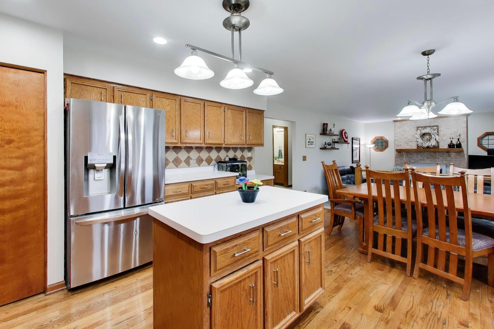 873 Hampton Drive Carol Stream, IL 60188 - Photo 13 of 43 a kitchen with stainless steel appliances granite countertop a sink stove and a large refrigerator