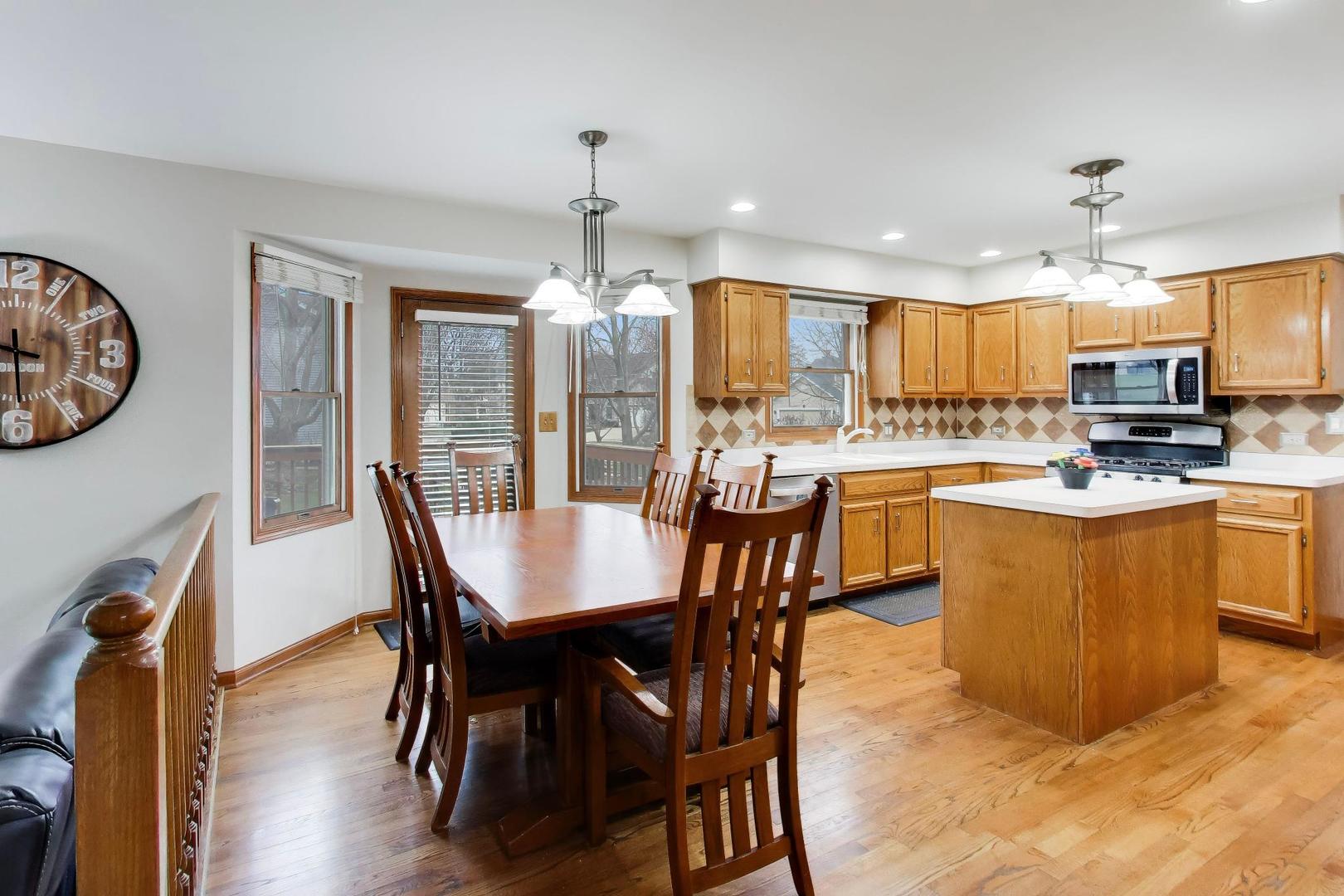 873 Hampton Drive Carol Stream, IL 60188 - Photo 15 of 43 a view of a dining room with furniture window and wooden floor