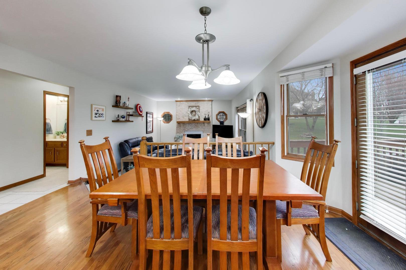 873 Hampton Drive Carol Stream, IL 60188 - Photo 16 of 43 a view of a dining room with furniture window and wooden floor