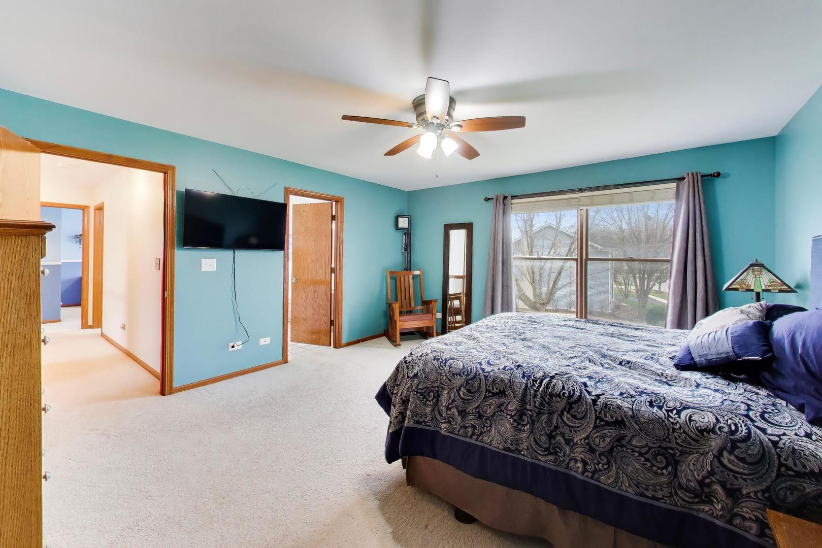 873 Hampton Drive Carol Stream, IL 60188 - Photo 23 of 43 a bedroom with a large bed a flat tv screen and dresser