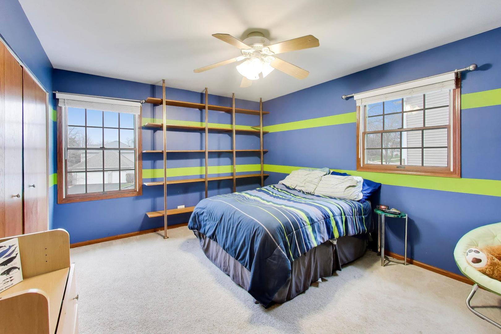 873 Hampton Drive Carol Stream, IL 60188 - Photo 27 of 43 a bedroom with a bed and a chandelier