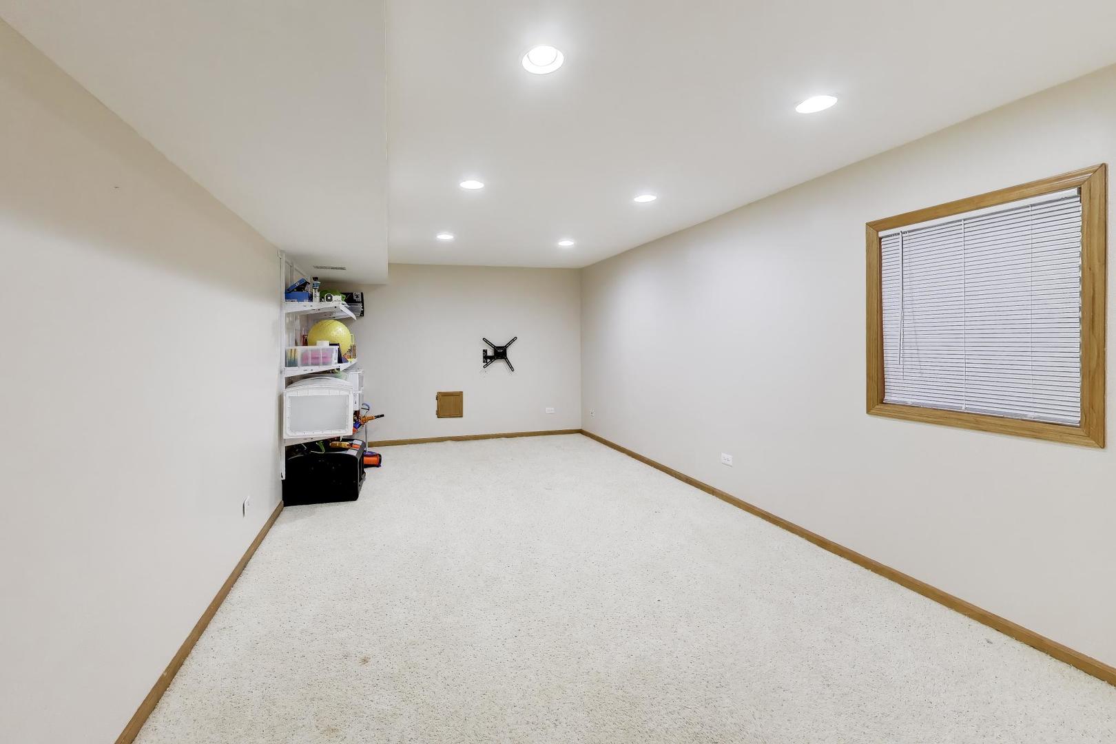 873 Hampton Drive Carol Stream, IL 60188 - Photo 34 of 43 an empty room with a refrigerator and window