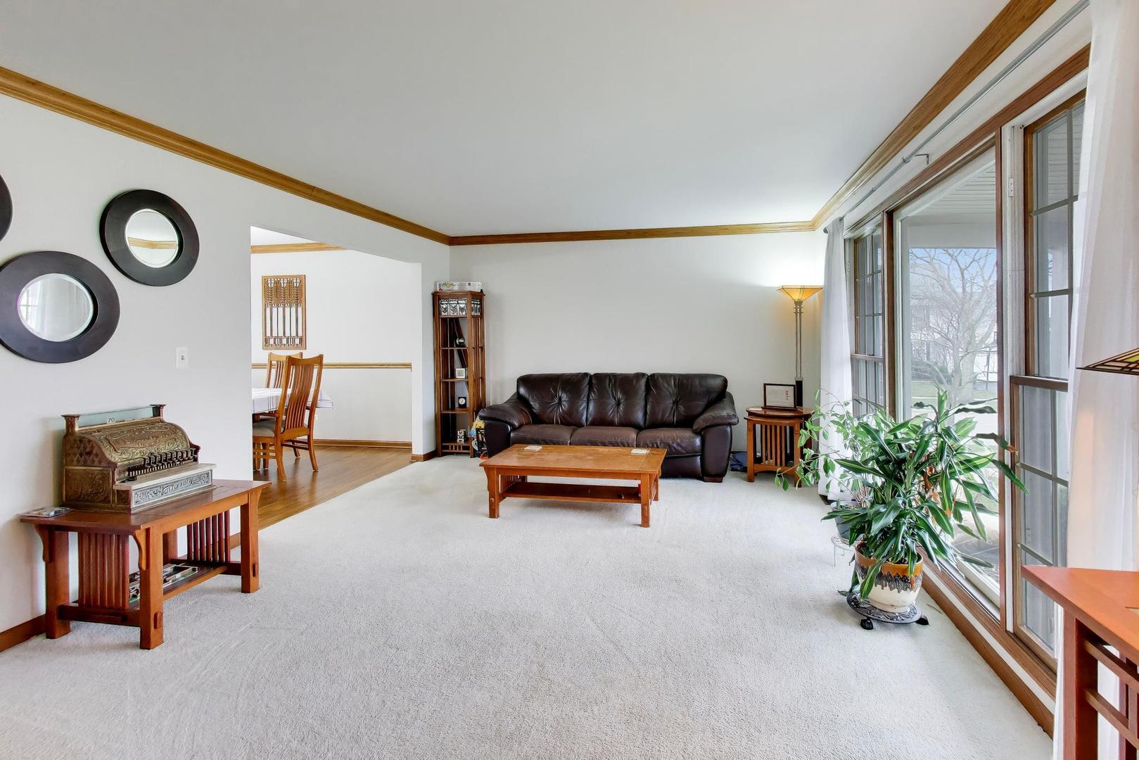 873 Hampton Drive Carol Stream, IL 60188 - Photo 7 of 43 a reading room with furniture and a lamp