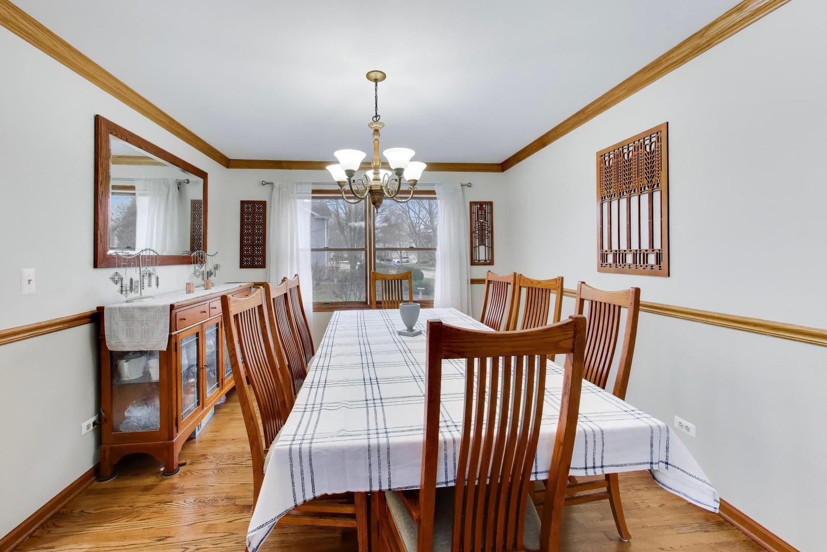 873 Hampton Drive Carol Stream, IL 60188 - Photo 10 of 43 a view of a dining room with furniture and wooden floor