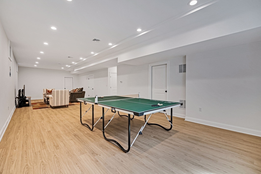 17 Sunrise Terrace Needham, MA 02492 - Photo 34 of 42 a living room with furniture pool table wooden floor and a rug
