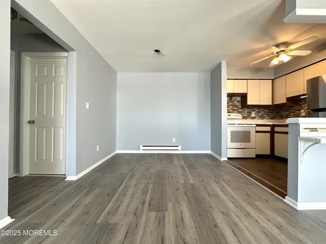 a view of a kitchen with wooden floor and a sink