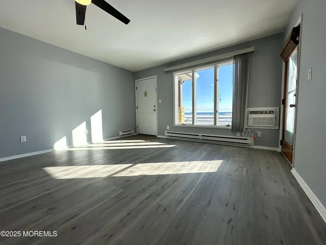 wooden floor in an empty room with a window
