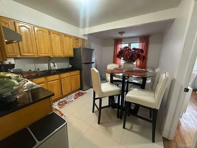 a view of a dining room with furniture and a chandelier