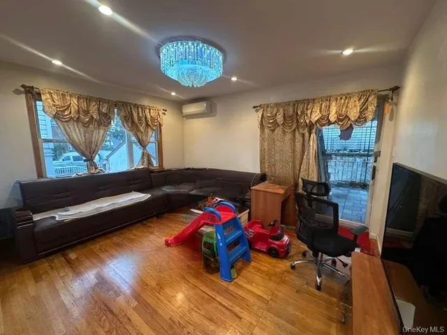 a bedroom with furniture and a large window