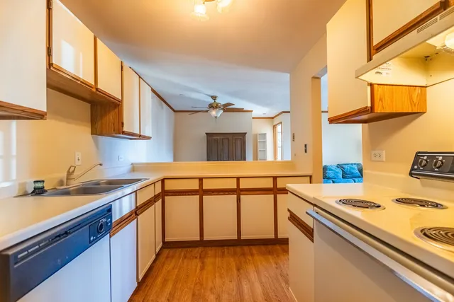 a kitchen with a sink a stove and cabinets