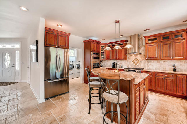 129 Turkey Run Road Trout Valley, IL 60013 - Photo 8 of 35 a kitchen with stainless steel appliances granite countertop a refrigerator a sink dishwasher a stove and a dining table with wooden floor