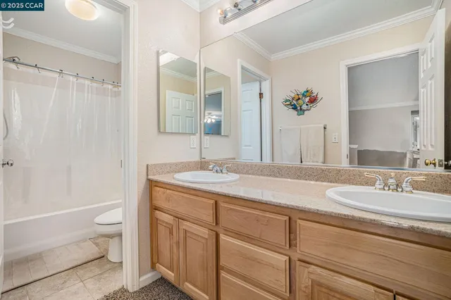 a bathroom with a granite countertop sink a toilet and a mirror