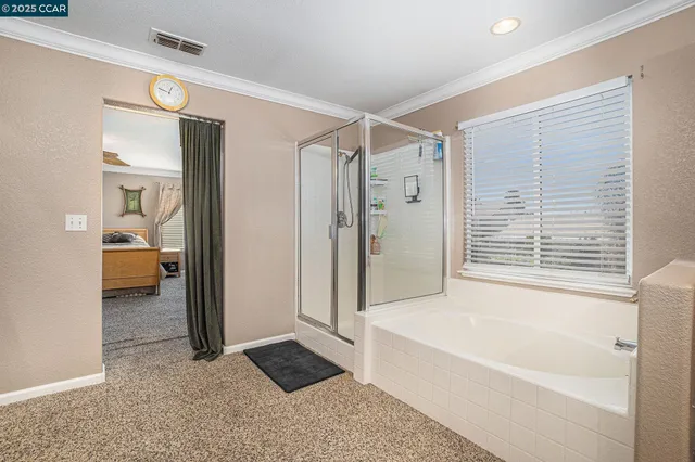 a spacious bathroom with a tub shower and a sink