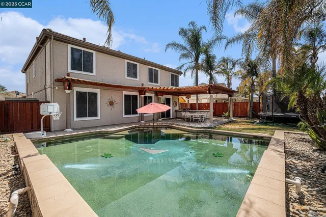a swimming pool with outdoor seating yard and barbeque oven