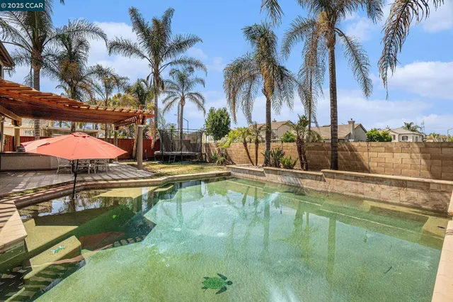 a view of a backyard with swimming pool