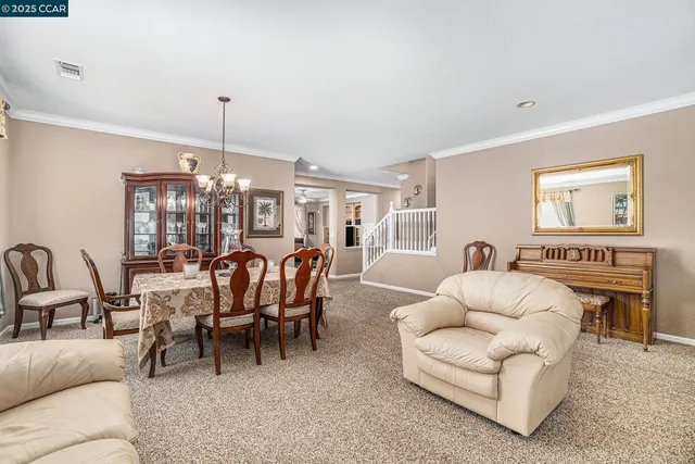 a living room with furniture kitchen view and a fireplace