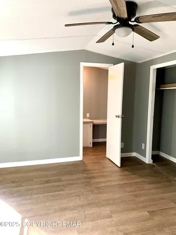 a view of a big room with wooden floor and cabinet