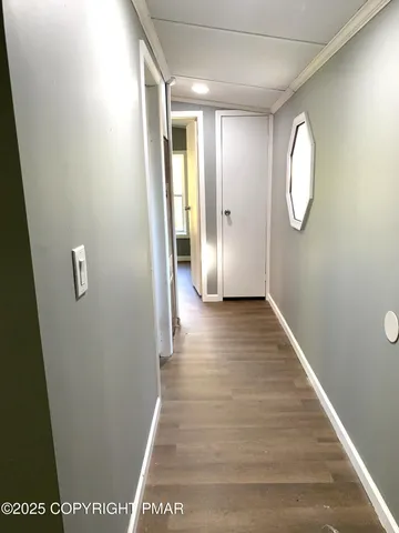a view of a hallway with wooden floor